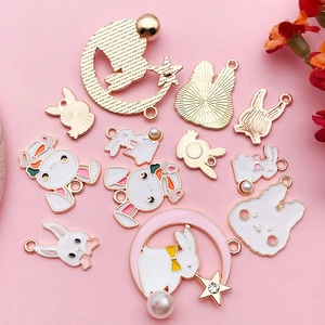 Detail of cute rabbit alloy charms with pink enamel and pearls for DIY jewelry making