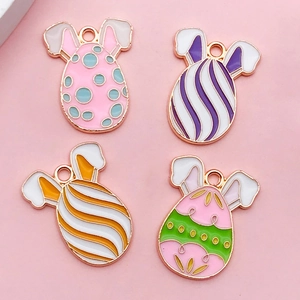 Detail of four colorful Easter egg charms with rabbit ears and polished alloy finish