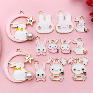 Detailed close-up of rabbit enamel pendants with pink moon and pearl alloy charms