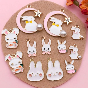 Detailed macro view of assorted rabbit alloy pendants with pink and white enamel finish