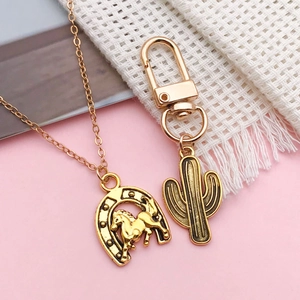 Golden cowboy horse horseshoe necklace and cactus charm with vintage relief texture