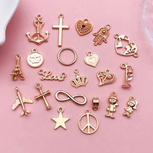 Various rose gold alloy charms including cross, heart lock, and crown for DIY jewelry