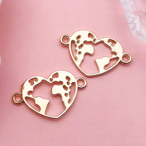 Macro view of rose gold heart-shaped world map jewelry connector charm for DIY crafts