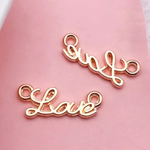 Detail of rose gold Love letter charms with double connectors for DIY jewelry making