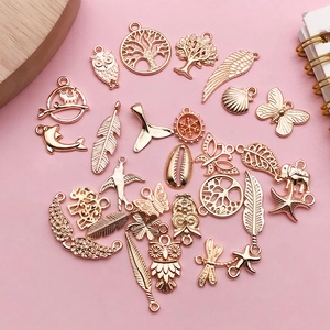 Macro view of assorted rose gold alloy charms including life tree and animal motifs