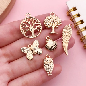 Assorted KC gold alloy DIY pendants including tree of life and butterfly designs