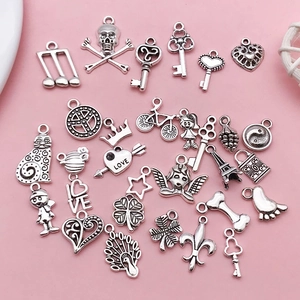 Detailed flat lay of 30 vintage silver alloy DIY charms including keys, hearts and animals