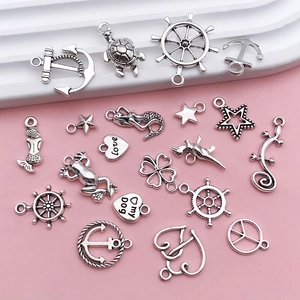 Macro shot of antique silver alloy charms featuring anchor, mermaid, and turtle designs