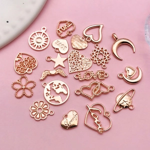 Close-up of rose gold alloy DIY charms in heart and star shapes for jewelry making