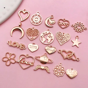 Macro shot of assorted rose gold hollow heart and LOVE charms for DIY jewelry making