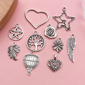 Detailed macro view of assorted vintage silver alloy charms for DIY jewelry making