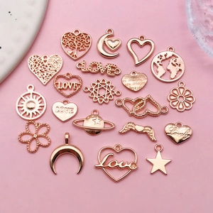 Macro view of rose gold DIY charms including heart, star, and moon shapes for jewelry