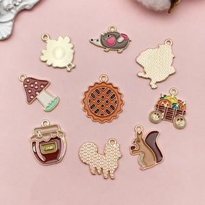 Detail of 8 autumn enamel charms featuring hedgehog, pumpkin and squirrel for DIY jewelry