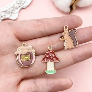 Detailed view of DIY alloy charms featuring a jam jar, mushroom, and squirrel for jewelry