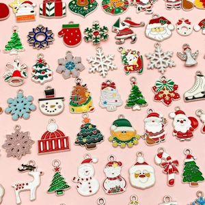 Christmas alloy charms collection featuring Santa, trees and snowflakes on pink background
