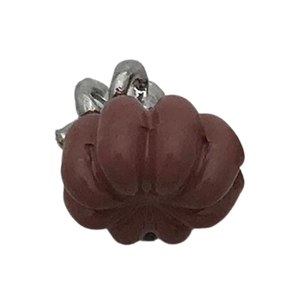Detailed view of an orange pumpkin charm with silver ring for DIY jewelry making