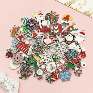 Christmas alloy charms set with Santa, reindeer and snowman on a soft pink background