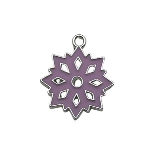 Close-up of a purple enamel snowflake charm with silver metal edges and hanging loop