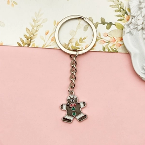 Charming gingerbread man keychain with brown enamel finish and festive bow tie on a ring