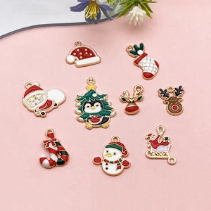 Detail of Christmas enamel alloy charms featuring Santa, tree, and reindeer for DIY jewelry