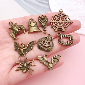 Set of antique bronze Halloween charms featuring pumpkins, bats and spiders for DIY jewelry