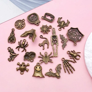 Detailed flat lay of antique bronze Halloween alloy charms for DIY necklace making