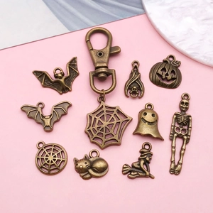 Detail of vintage bronze Halloween alloy pendants with pumpkin, bat and spider web