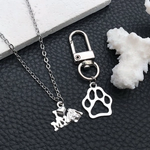 Silver dog theme set with 'I Heart My Dog' necklace and hollow paw print keychain