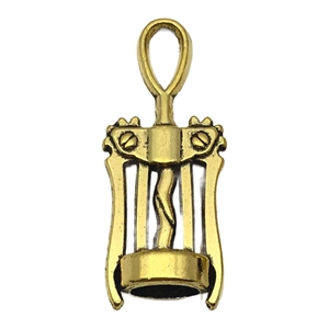 Detail of vintage bronze wine opener charm with intricate lever and spiral patterns