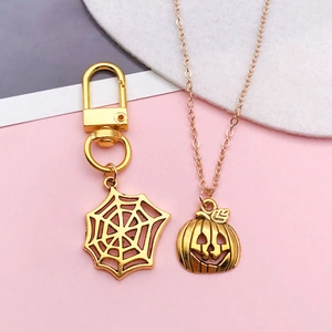 Halloween gold alloy keychain set featuring a detailed spider web and jack-o-lantern design