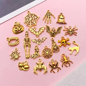 Detailed collection of antique gold Halloween pendants featuring spiders and skeletons