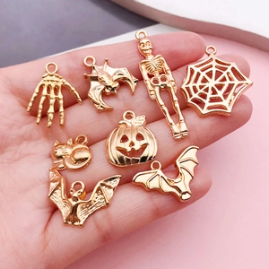 Mix of gold-plated Halloween charms including pumpkins, spiders, and skeletons for DIY jewelry