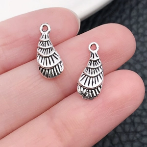 Macro shot of silver-plated shell pendants with detailed radial textures and top hanging holes