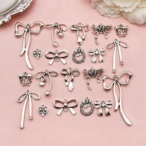 Selection of silver bow-shaped alloy pendants for DIY jewelry making and handmade crafts