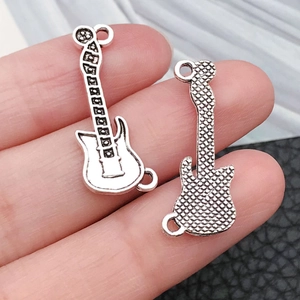 Detailed close-up of double-sided guitar charms for DIY necklaces and bracelets