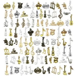 Assorted musical instrument charms including guitars and notes in antique metal finishes