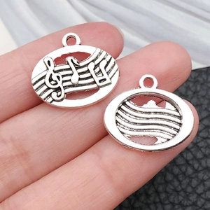 Macro view of vintage silver treble clef music charms for DIY necklaces and bracelets