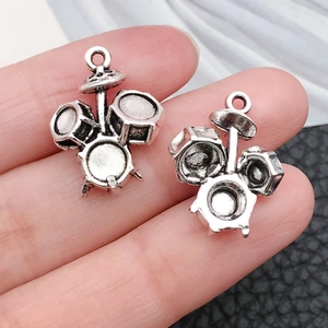 Macro shot of miniature antique silver drum pendants for DIY jewelry crafting