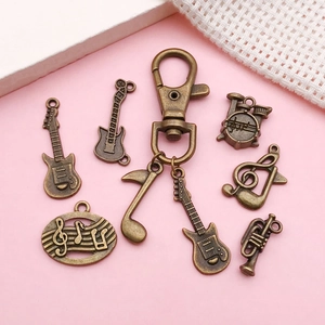 Antique bronze music charm set with guitar, drum, and treble clef pendants for DIY jewelry