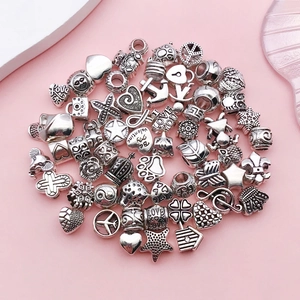 Macro shot of silver alloy charm beads featuring heart star and anchor shapes for DIY jewelry