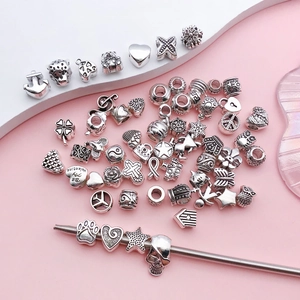 Assorted silver alloy charms for DIY jewelry making featuring heart and star shapes