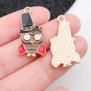 Macro view of owl enamel alloy pendant with gentleman hat showing front and back details