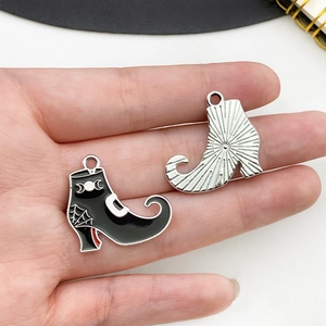 Detail of Gothic boot charm with black enamel, silver moon patterns and spider web design