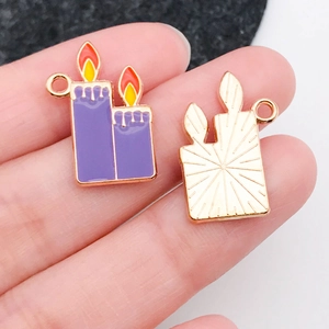 Detail of purple candle enamel charms for Halloween jewelry with golden metal backing