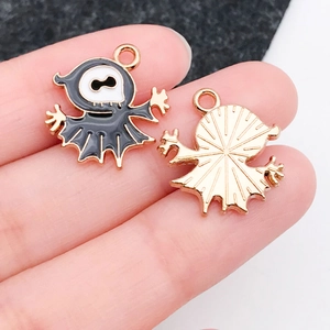 Macro detail of Halloween cartoon enamel charms showing gold plating and textures