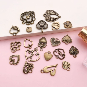 Detailed view of assorted antique bronze heart-shaped DIY charms for jewelry making