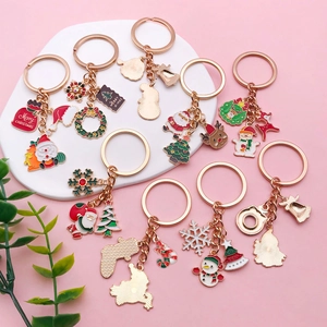 Christmas keychain set with Santa, reindeer, and snowman charms in gold enamel finish
