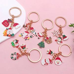 Detail of Christmas metal keychains with festive charms and colorful enamel finish