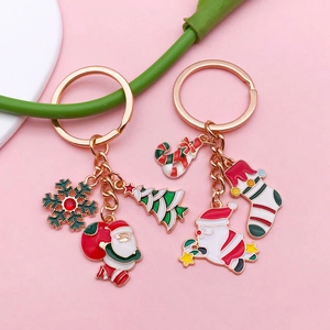 Detail view of rose gold Christmas keychains with Santa Claus, tree and enamel charms