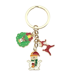 Christmas keychain with reindeer snowman and wreath pendants in gold alloy finish